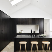Modern black and white kitchen in home designed by Niche Interiors and William Duff Architects